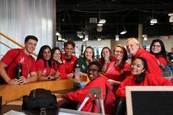 A group of building managers around the recreation center front circle desk