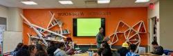 Students in classroom with strange bookshelf