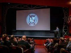 President Jonathan Koppell speaks to an audience at a Town Hall.